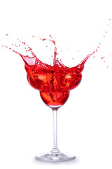 Red cocktail splashing out of a margarita glass isolated on white background.