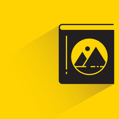 book with shadow on yellow background