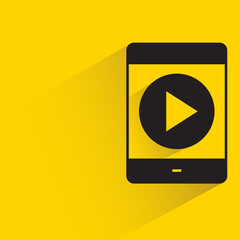 smartphone and video player with shadow on yellow background