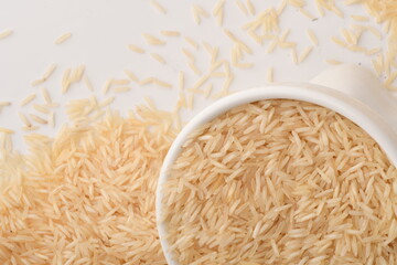 uncooked long brown rice isolated on white