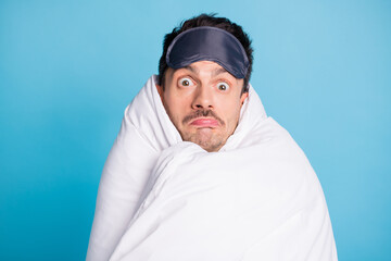 Photo portrait of confused man wrapped in blanket isolated on vivid blue colored background