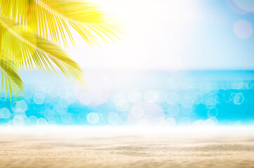 Blur beautiful nature green palm leaf on tropical beach with bokeh sun light wave abstract background.