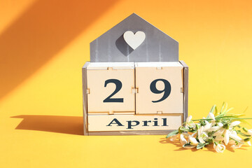 Calendar for April 29 : cubes with the number 29, the name of the month of April in English, a...