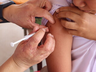 closeup of the doctor injecting the patient with the syringe in the hospital. health care.