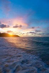 Obraz premium Summer time background beach, wave, sunset, cloud and blue sea as vertical image.