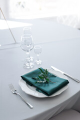 glass glasses and a white plate with a napkin on the table