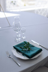 glass glasses and a white plate with a napkin on the table