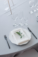 glass glasses and a white plate with a napkin on the table
