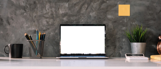 Cropped shot of workspace with mock-up laptop with white blank screen, Home interior or office...