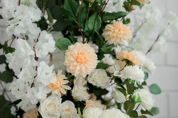 close-up of artificial flowers of white and pink color in the room.