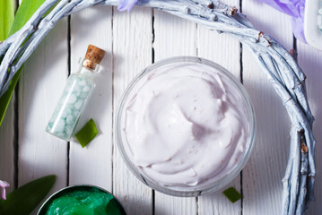 cosmetic cream product samples with hyacinth flowers on white wooden background