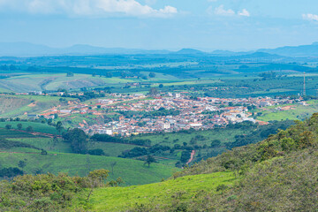 View from far away of the Brazilian Mineira city of São Roque de Minas and rural areas around. Panoramic view of the city and farms.