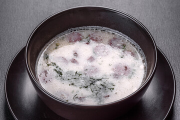 Cheese soup with fried sausages and herbs. Tasty cream cheese soup