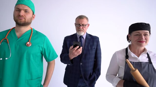Portrait of three people of different professions and occupations standing side by side on a white background. Businessman, doctor and cook in uniform