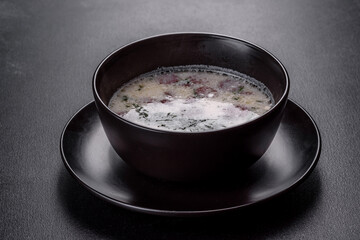 Cheese soup with fried sausages and herbs. Tasty cream cheese soup