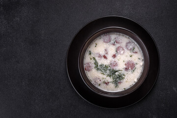 Cheese soup with fried sausages and herbs. Tasty cream cheese soup
