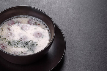 Cheese soup with fried sausages and herbs. Tasty cream cheese soup