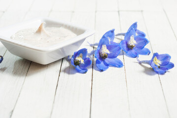 Cosmetic cream and blue flower