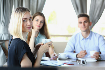 Fototapeta premium Business meeting in a cafe young beautiful men