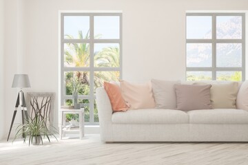 Fototapeta premium White living room with sofa and summer landscape in window. Scandinavian interior design. 3D illustration