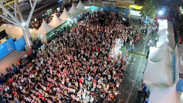 Large crowd of people exciting at the sport event. football game. Public viewing
