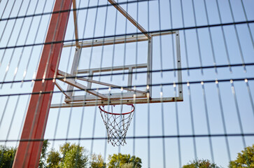 Basketball court from behind fence. Selective focus, blurred background