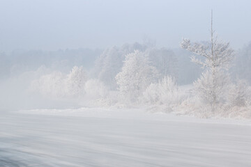 Winter morning by the river. Europe, Poland, the Pilica River. Floe, frost and rime.