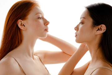 Multiracial two women posing and looking in opposite directions
