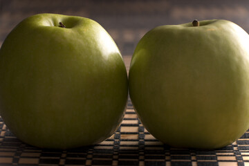Ripe green apple on kitchen table