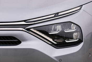 Front lights of a silver car, LED technology