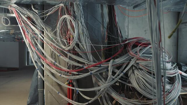 chaotically laid network cables in the basement of the house. Laying of an Internet cable.