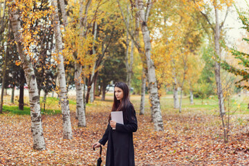 Asian Woman Outdoors In Autumn