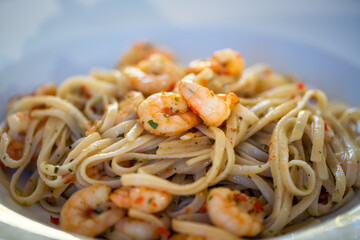 Spaghetti aglio e olio with shrimp. Healthy, simple and delicious pasta dish. Close up of the plate.