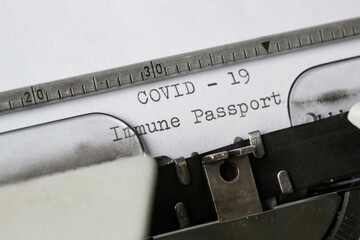 COVID -19 Immune Passport text on blank paper typed on a retro typewriter