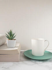 Fototapeta na wymiar 洋書の上に置かれた多肉植物と白いコーヒーカップ