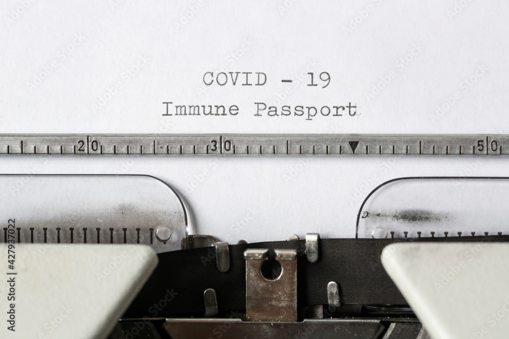 Fototapete covid -19 immune passport text on blank paper typed on a retro typewriter