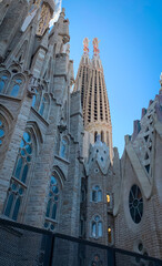 Low angle side view to the towers of Passion Facade of the Gaudi's Sagrada Familia. Barcelona, Spain