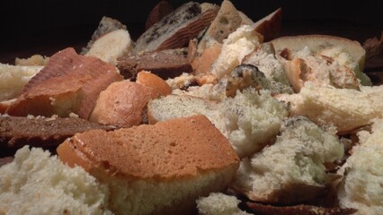 Uneaten wasted bread. Food loss and waste. Food wasting. Discarded moldy bread close up. Growth of toxic black mold