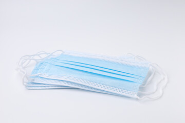 Blue disposable surgical face mask. Mask medical for protective coronavirus place stacks isolated.