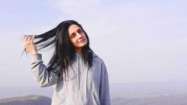 Zoom out view young caucasian woman portrait look straight camera in scenic nature. Freedom well being women concept.
