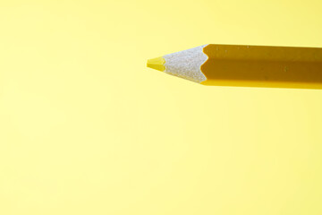 Colorful crayons, pencils with plain paper as a background with structure