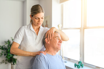 Fototapeta premium A Modern rehabilitation physiotherapy worker with senior client