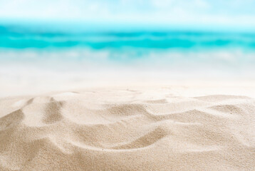 Empty sandy beach. Little shells in the sand. Splashing waves on the seashore. Summer.
