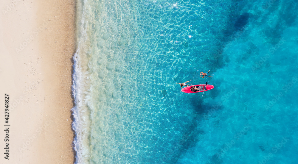 Wall mural kayaking. sup. aerial view of floating board and people on blue sea at sunny day. summer seascape. l
