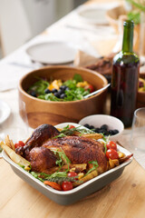 Close-up of roasted chicken with vegetables in dish on the table served for dinner