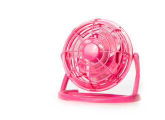 Mini fan. Portable battery operated hot pink small table ventilator to cool down and circulate air during hot summer days. Use at the office, car trips and camping. Isolated on white. Selective focus.