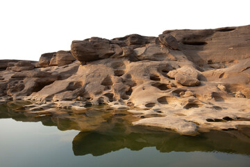 Cliff stone located part of the mountain rock shape look like the dog’s head reflection on river water