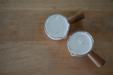 Freshly whipped cream in small glass cup ingredient for food or beverage