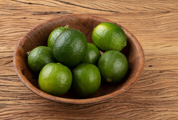 Lemons in a bowl over wooden table