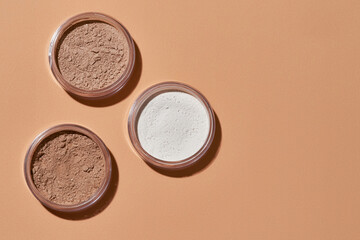 Round cans filled with cosmetological powder without caps